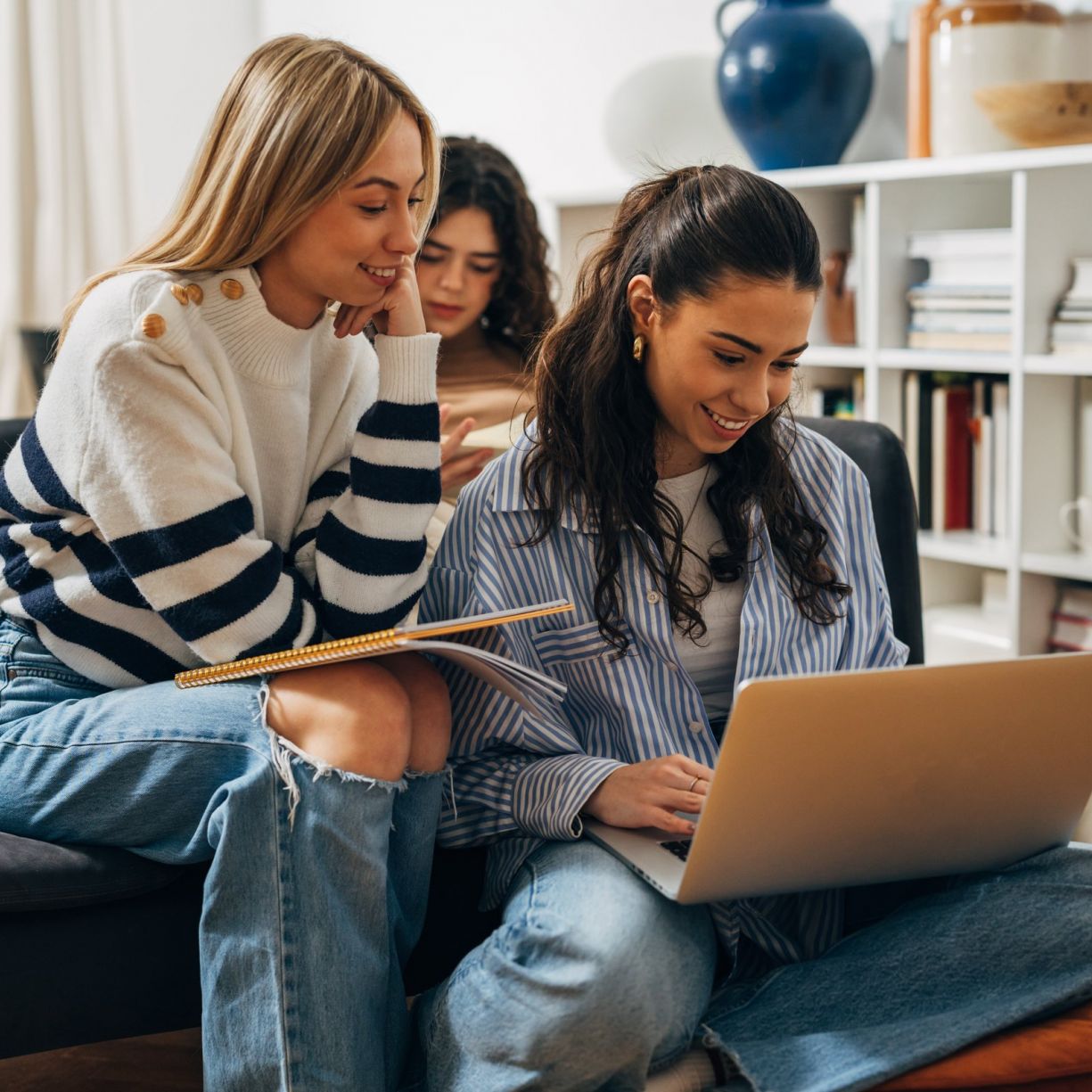 Happy college friends working on a group project together