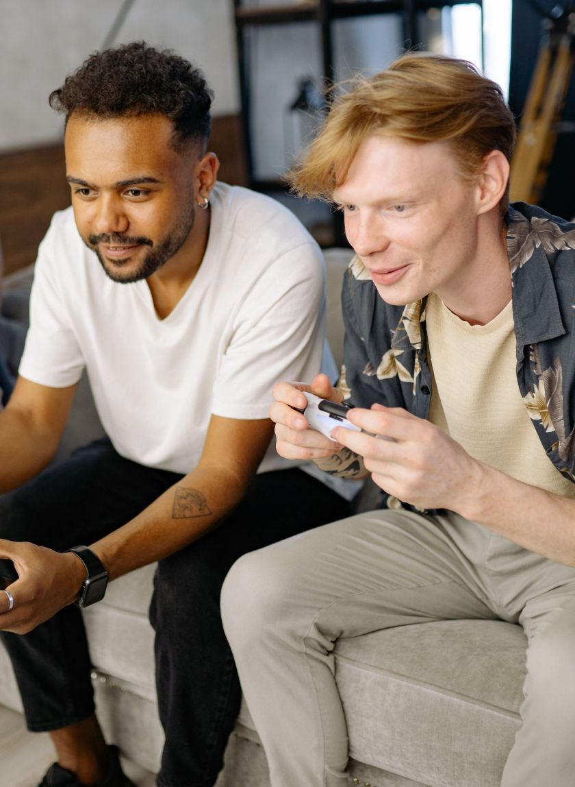 Young adult friends playing video games in the student lounge